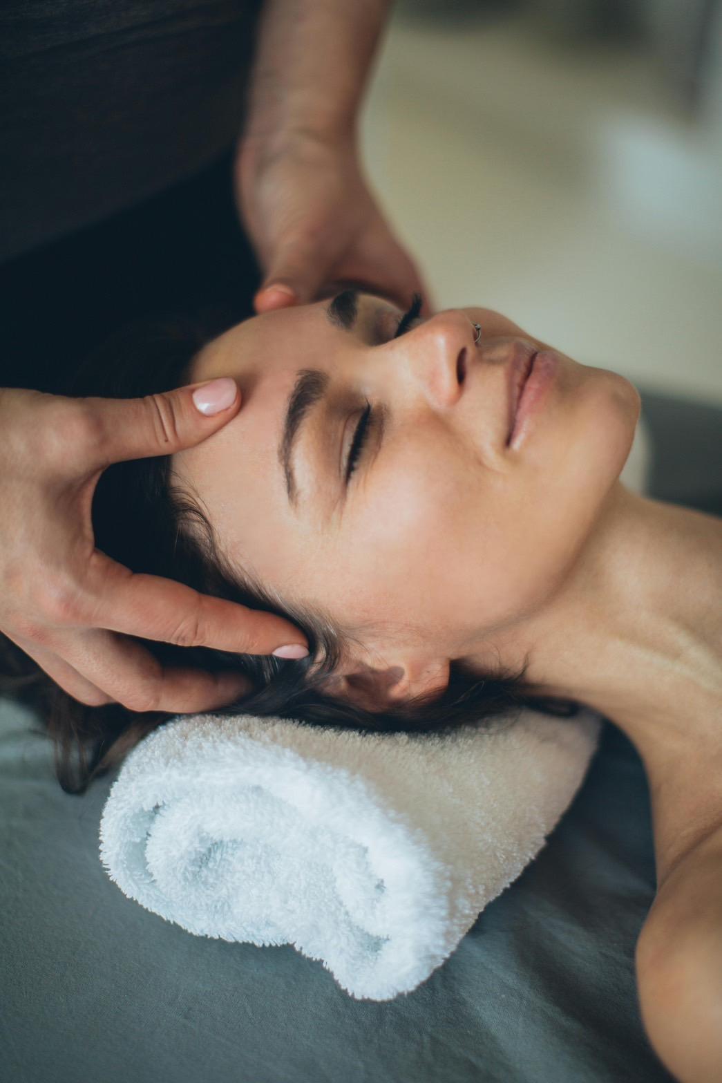 The beautiful lady is smiling during a massage session.